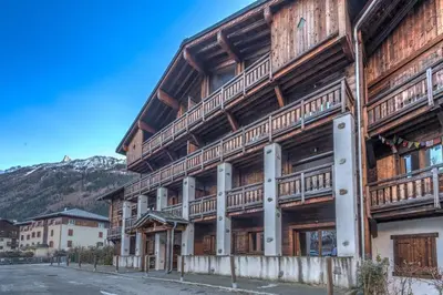 a wooden building with wooden balconies on a street at Belvédère du Brévent - Welkeys in Chamonix-Mont-Blanc