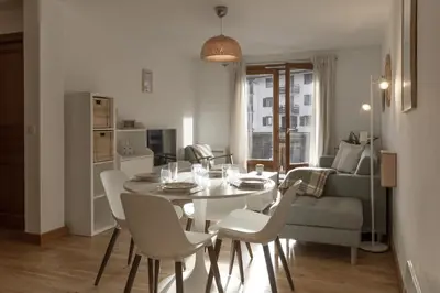 a dining room and living room with a table and chairs at Capucins 3 in Chamonix-Mont-Blanc