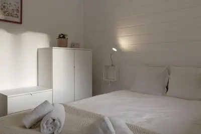 a bedroom with a bed with white sheets and a phone at Capucins 3 in Chamonix-Mont-Blanc