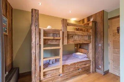 a couple of bunk beds in a room at Duplex Megèvan - Welkeys in Megève