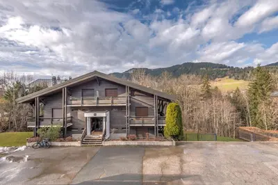a large house with a driveway in front of it at Duplex Megèvan - Welkeys in Megève