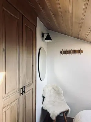 a room with a bed and a mirror and a closet at Appartement avec vue sur les Dômes du Miage in Les Contamines-Montjoie