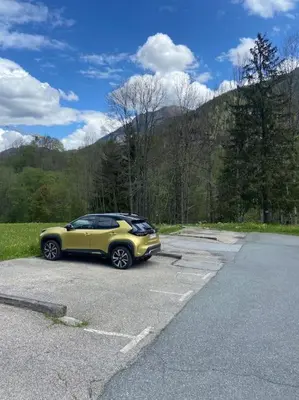 a yellow car parked in a parking lot at Appartement avec vue sur les Dômes du Miage in Les Contamines-Montjoie