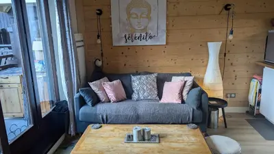 a living room with a couch and a coffee table at Central Mont Blanc View Apartment, balcony, free parking in Chamonix-Mont-Blanc