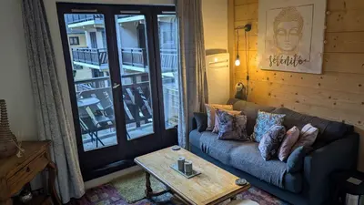 a living room with a couch and a coffee table at Central Mont Blanc View Apartment, balcony, free parking in Chamonix-Mont-Blanc