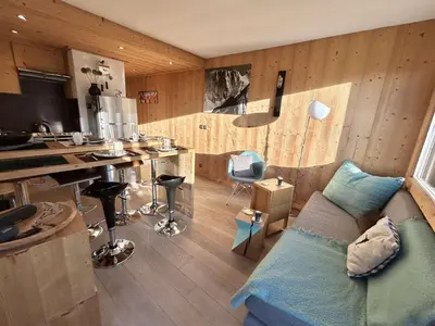 a living room with a couch and a kitchen at Charmant 2 pièces + cabine à Megève, proche remontées et parking inclus - FR-1-597-185 in Megève