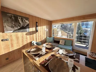 a kitchen with a wooden table and a large window at Charmant 2 pièces + cabine à Megève, proche remontées et parking inclus - FR-1-597-185 in Megève