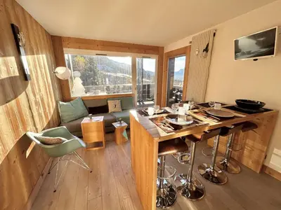 a living room with a wooden table and a couch at Charmant 2 pièces + cabine à Megève, proche remontées et parking inclus - FR-1-597-185 in Megève