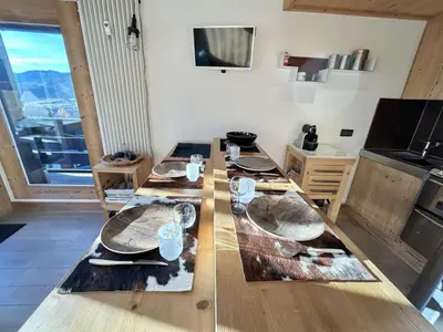 a wooden table with plates on it in a kitchen at Charmant 2 pièces + cabine à Megève, proche remontées et parking inclus - FR-1-597-185 in Megève