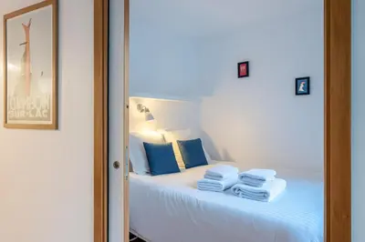 a bedroom with a large white bed and a couch at Escape in Chamonix breathtaking view Mont-Blanc in Chamonix-Mont-Blanc