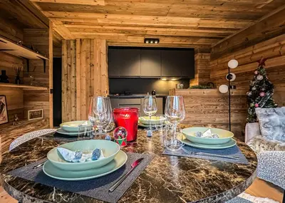 a table with plates and glasses on it in a cabin at Stella Megeve Palais garage in Megève