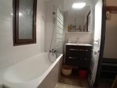a white bathroom with a tub and a sink at Studio cabine rénové près ski bus, 4 couchages - FR-1-572-301 in Arâches-la-Frasse