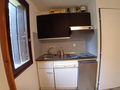 a small kitchen with a sink and a dishwasher at Studio cabine rénové près ski bus, 4 couchages - FR-1-572-301 in Arâches-la-Frasse