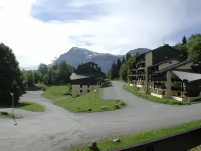 a street in a village with buildings and mountains at Studio cabine rénové près ski bus, 4 couchages - FR-1-572-301 in Arâches-la-Frasse