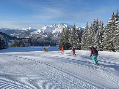 a group of people skiing down a snow covered slope at Studio cabine rénové près ski bus, 4 couchages - FR-1-572-301 in Arâches-la-Frasse