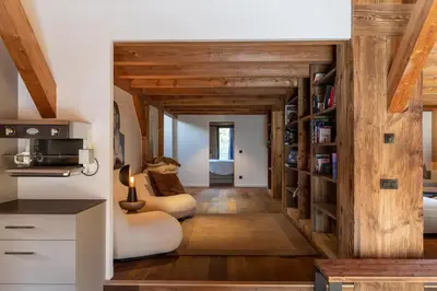 a living room with wooden walls and wooden floors at Chalet de 8 chambres MEGEVE - 16 personnes in Megève