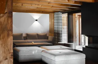 a living room with a couch and a table at Chalet de 8 chambres MEGEVE - 16 personnes in Megève