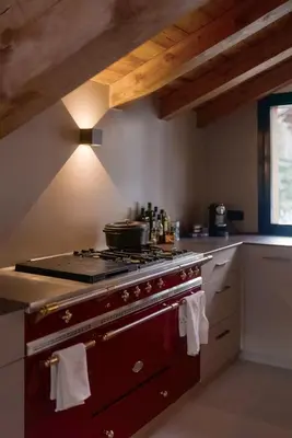 a kitchen with a stove with a pot on it at Chalet de 8 chambres MEGEVE - 16 personnes in Megève