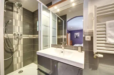 a bathroom with a sink and a shower at Chalet Minouche in Chamonix-Mont-Blanc