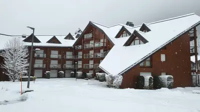 a building covered in snow with snow covered roofs at Appartement proche télécabine! Séjour tout inclu! in Les Contamines-Montjoie