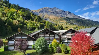 a resort with a mountain in the background at Appartement proche télécabine! Séjour tout inclu! in Les Contamines-Montjoie