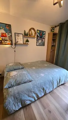 a bedroom with a large bed in a room at Appartement proche télécabine! Séjour tout inclu! in Les Contamines-Montjoie