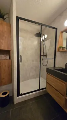 a shower with a glass door in a bathroom at Appartement proche télécabine! Séjour tout inclu! in Les Contamines-Montjoie