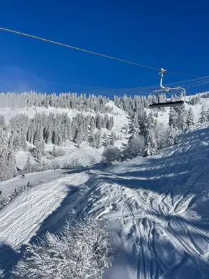 a person skiing down a snow covered ski slope at Le Marlotte in Les Carroz d'Araches