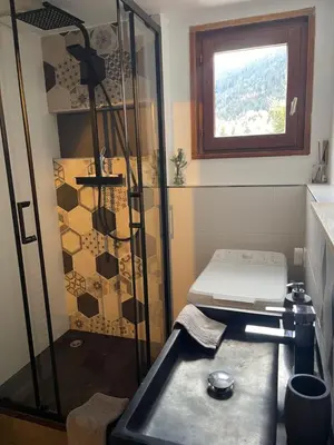 a bedroom with a door leading to a bed at Le Marlotte in Les Carroz d'Araches