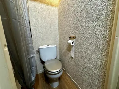 a bathroom with a toilet and a roll of toilet paper at Les Esserts au pied des pistes idéal 4 personnes in Morillon