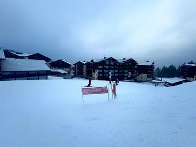 a sign in the snow in front of a resort at Les Esserts au pied des pistes idéal 4 personnes in Morillon