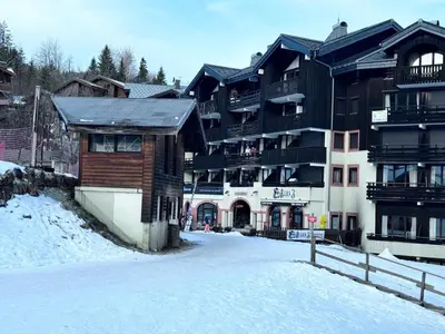 a large building in the snow in front at Les Esserts au pied des pistes idéal 4 personnes in Morillon