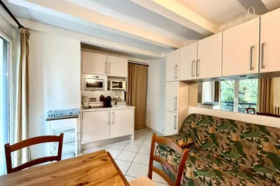 a kitchen and dining room with a table and chairs at Apartment 2 rooms near the slopes in Combloux