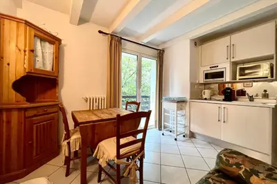 a kitchen with a table and a dining room at Apartment 2 rooms near the slopes in Combloux