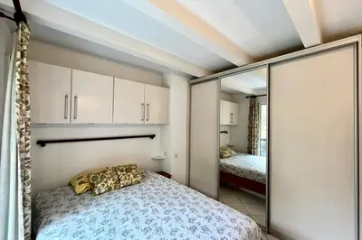 a bedroom with a bed and a mirror at Apartment 2 rooms near the slopes in Combloux