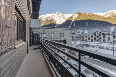 a balcony with a view of a city and mountains at Apt Le Lyret in Chamonix-Mont-Blanc