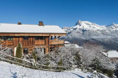a log cabin in the snow with a mountain at Belmont - New & ecological chalet in the heart of Combloux in Combloux