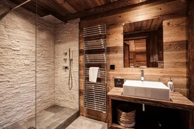 a bathroom with a sink and a glass shower at Belmont - New & ecological chalet in the heart of Combloux in Combloux