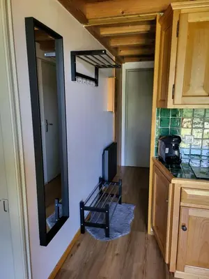 a room with a mirror and a chair in a kitchen at Studio Mezzanine Les Combettes E in Les Contamines-Montjoie