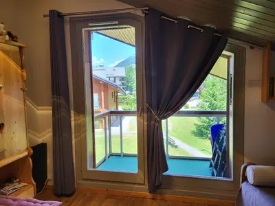 a window with a view of a yard at Studio Mezzanine Les Combettes E in Les Contamines-Montjoie