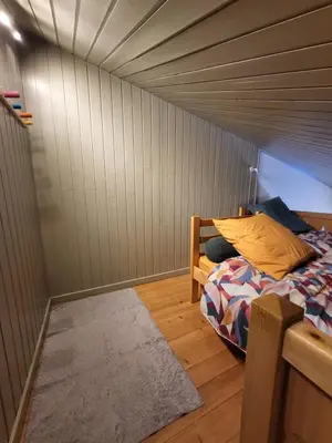 a small room with a bed and a rug at Studio Mezzanine Les Combettes E in Les Contamines-Montjoie