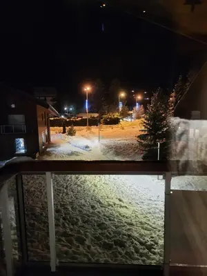 a view of a snow covered street at night at Studio Mezzanine Les Combettes E in Les Contamines-Montjoie