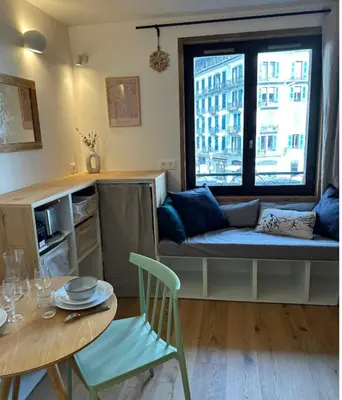a living room with a couch and a table at Charming Mont-Blanc View Studio in Chamonix in Chamonix-Mont-Blanc