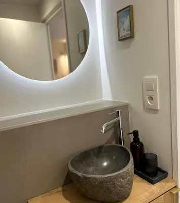 a bathroom with a sink with a mirror at Charming Mont-Blanc View Studio in Chamonix in Chamonix-Mont-Blanc