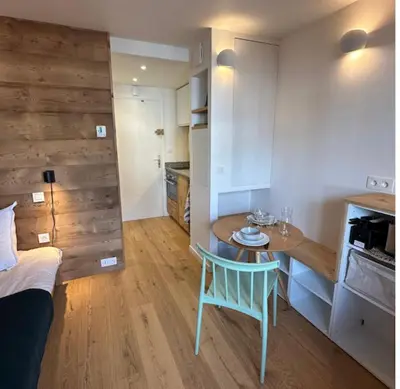 a small room with a table and a bed at Charming Mont-Blanc View Studio in Chamonix in Chamonix-Mont-Blanc