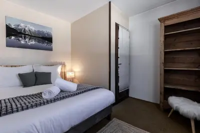 a bedroom with a large bed and a closet at Le Miage in Chamonix-Mont-Blanc