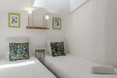 two beds sitting next to each other in a room at Le Triolet - Centre-ville - Balcon avec vue in Chamonix-Mont-Blanc