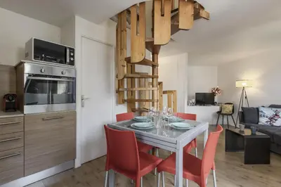 a kitchen and dining room with a table and chairs at Le Triolet - Centre-ville - Balcon avec vue in Chamonix-Mont-Blanc