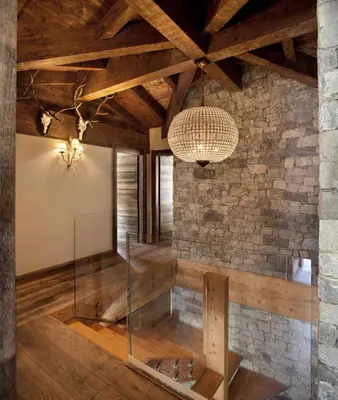 a glass exhibit in a room with a stone wall at Chalet Alta in Chamonix-Mont-Blanc