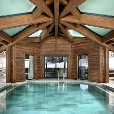 an indoor swimming pool with a wooden ceiling at Chalet Alta in Chamonix-Mont-Blanc